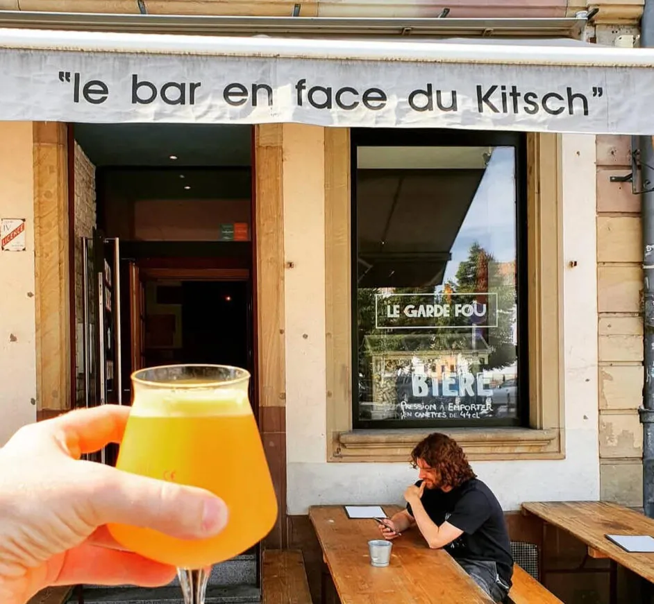 La devanture du Garde Fou, store « le bar en face du Kitsch », une bière trouble levée au premier plan